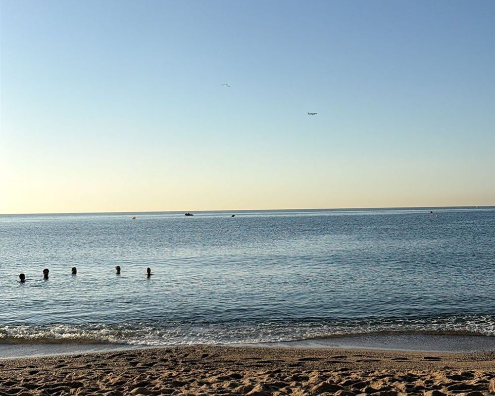 Calm sea and golden sand on a Barcelona beach at sunrise